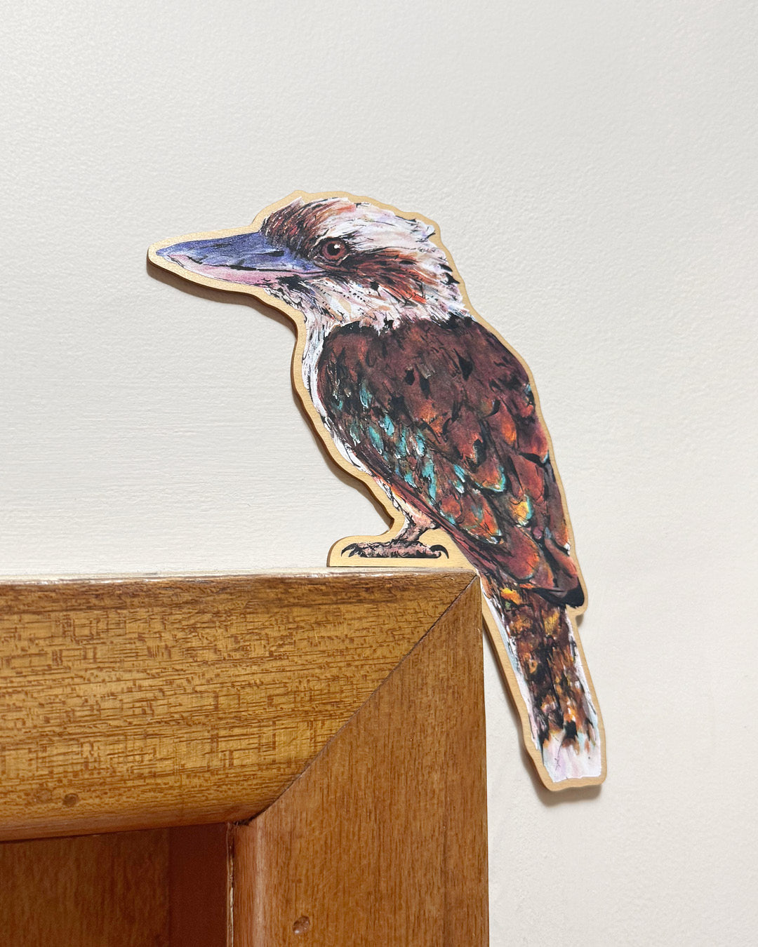 Laughing Kookaburra door topper featuring Australian bird artwork perched on a door frame by artist Shannon Dwyer